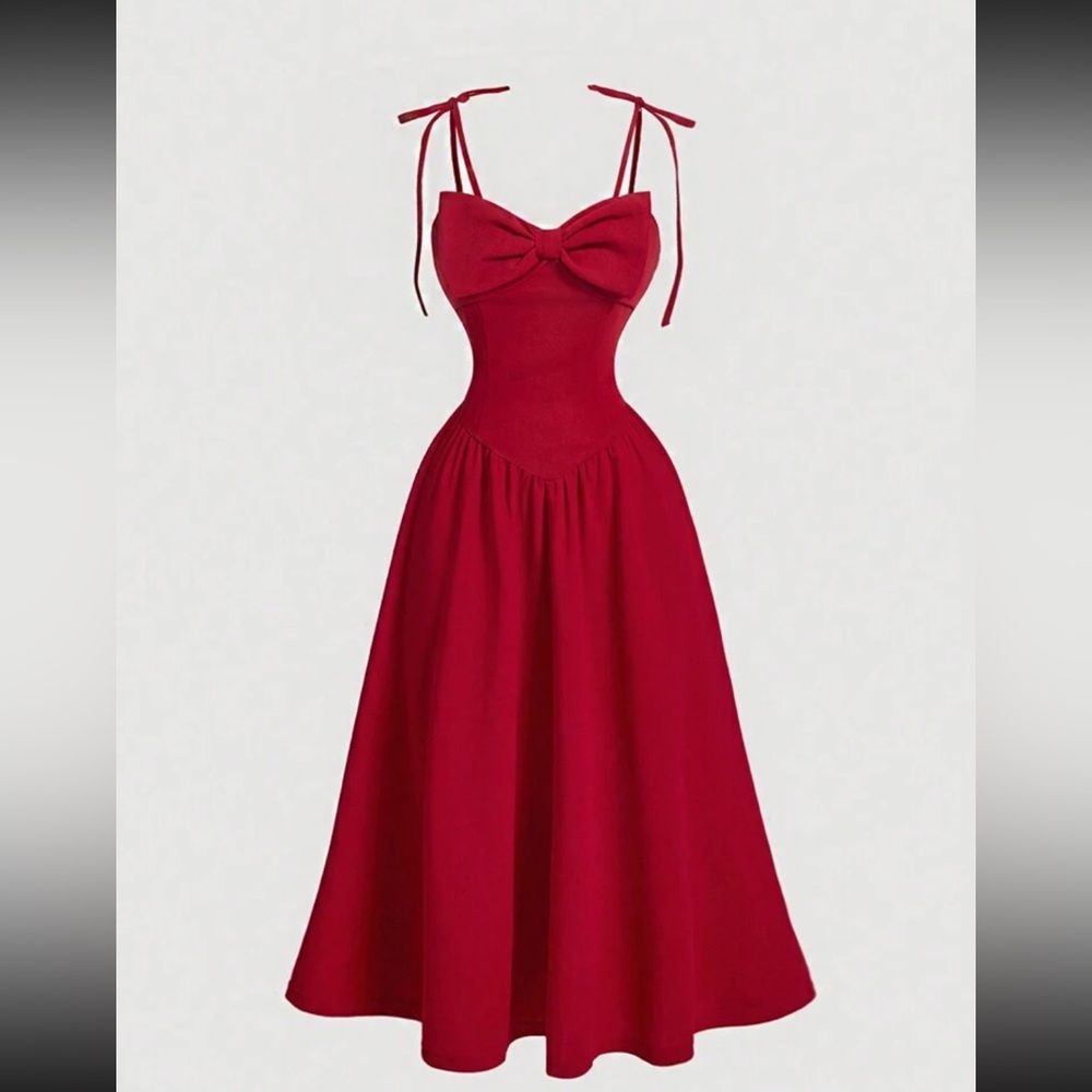 red flowy dress with skinny straps and cute bow detail on the bodice